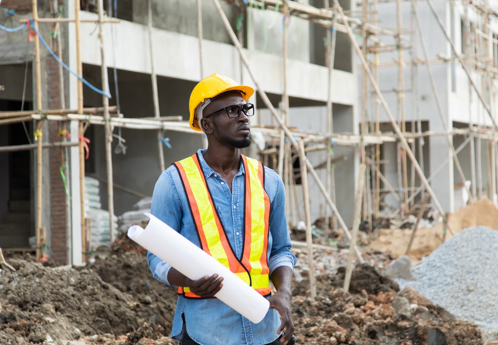 african-american-businessman-protective-safety-hard-hat-looking-blueprin-t-plans-constru-ction-site-1